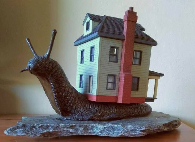 image of a snail carrying a house on its back