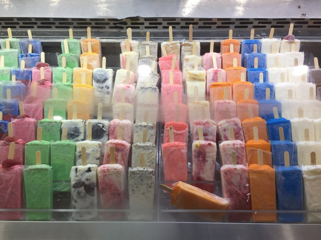 photo of brightly colored paletas (iced sweet treats on sticks)