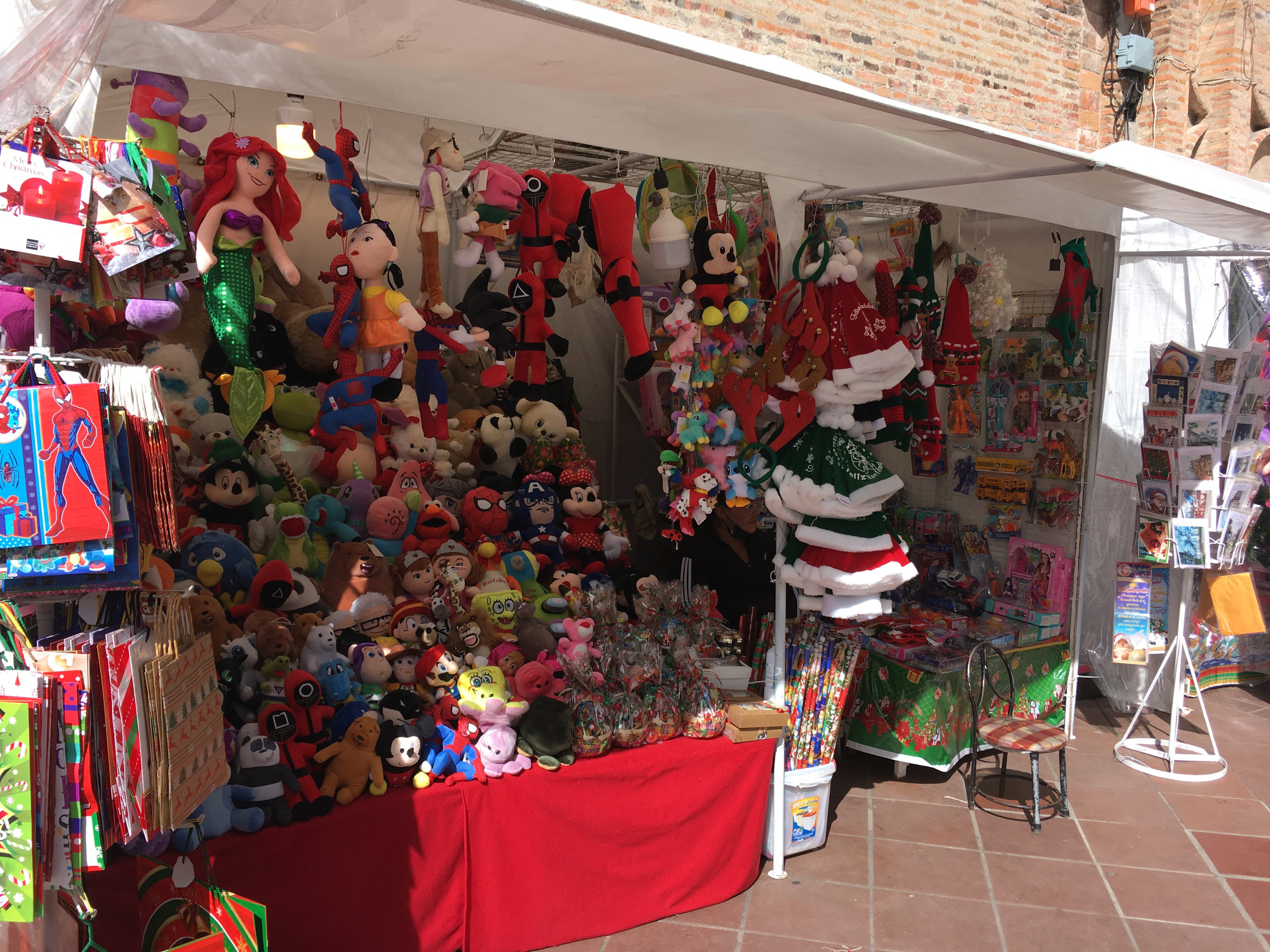 Photo of a small shop selling items on the street.