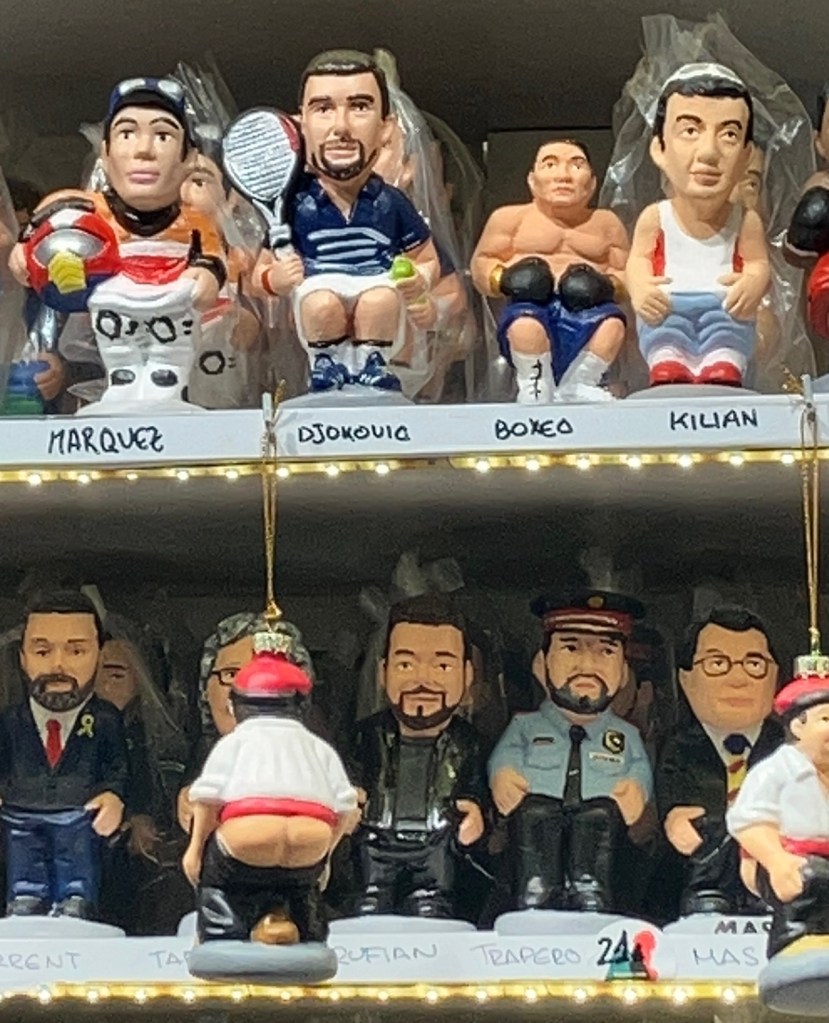 photo of a shelf featuring figurines squatting in a pooping position