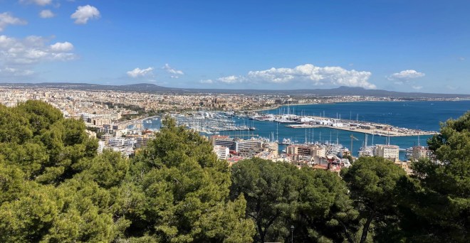 Photo of Palma, the capital city of an island in the Mediterranean sea showing the expanse of buildings and the marina with many boats