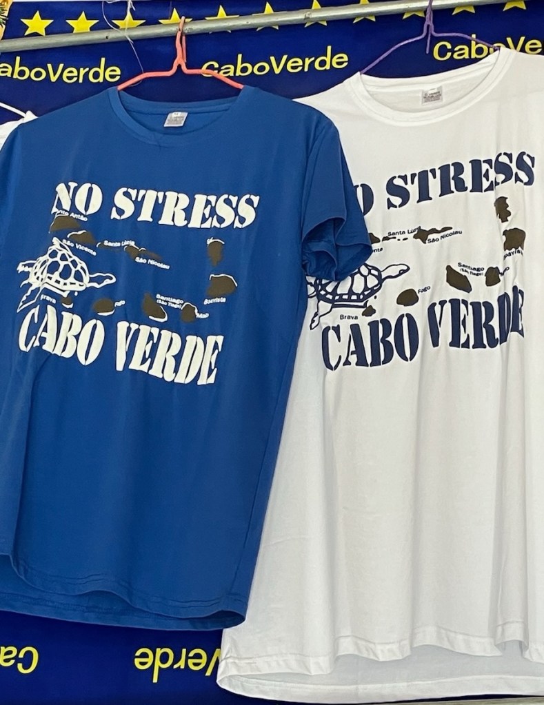 photo of two t-shirts, one blue and one white, saying No Stress Cabo Verde