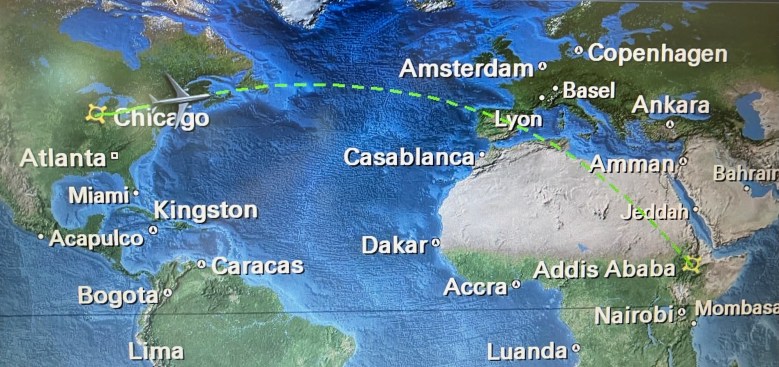 image of a map with North America and the top of south America on the left, Europe and the top half of Africa on the right, with a green dotted line indicating a flight from Chicago in the northern middle of North America to Addis Ababa in the middle-eastern edge of Africa