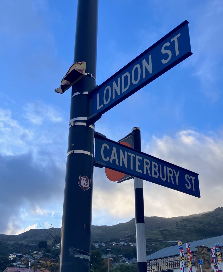photo of a pole with two street signs in blue and white, one saying LONDON ST and the other CANTERBURY ST