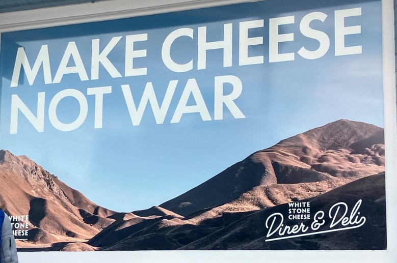 photo of a billboard whose headline is MAKE CHEESE NOT WAR