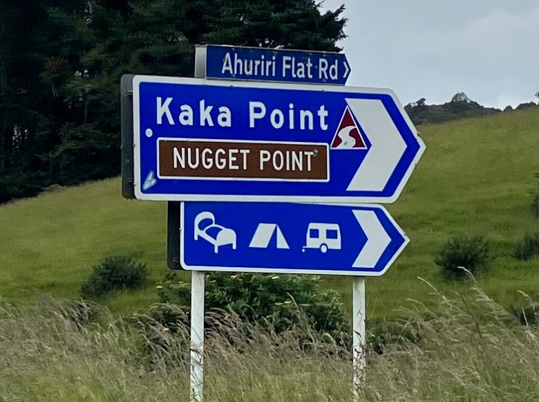 photo of blue and white directional signs reading Kaka Point and Nugget Point