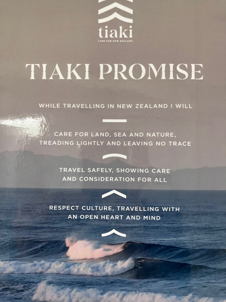 photo of a poster headlined "TIAKI PROMISE" and including: while travelling in New Zealand I will - care for land, sea and nature, treading lightly and leaving no trace; travel safely, showing care and consideration for all; respect culture, travelling with an open heart and mind.
