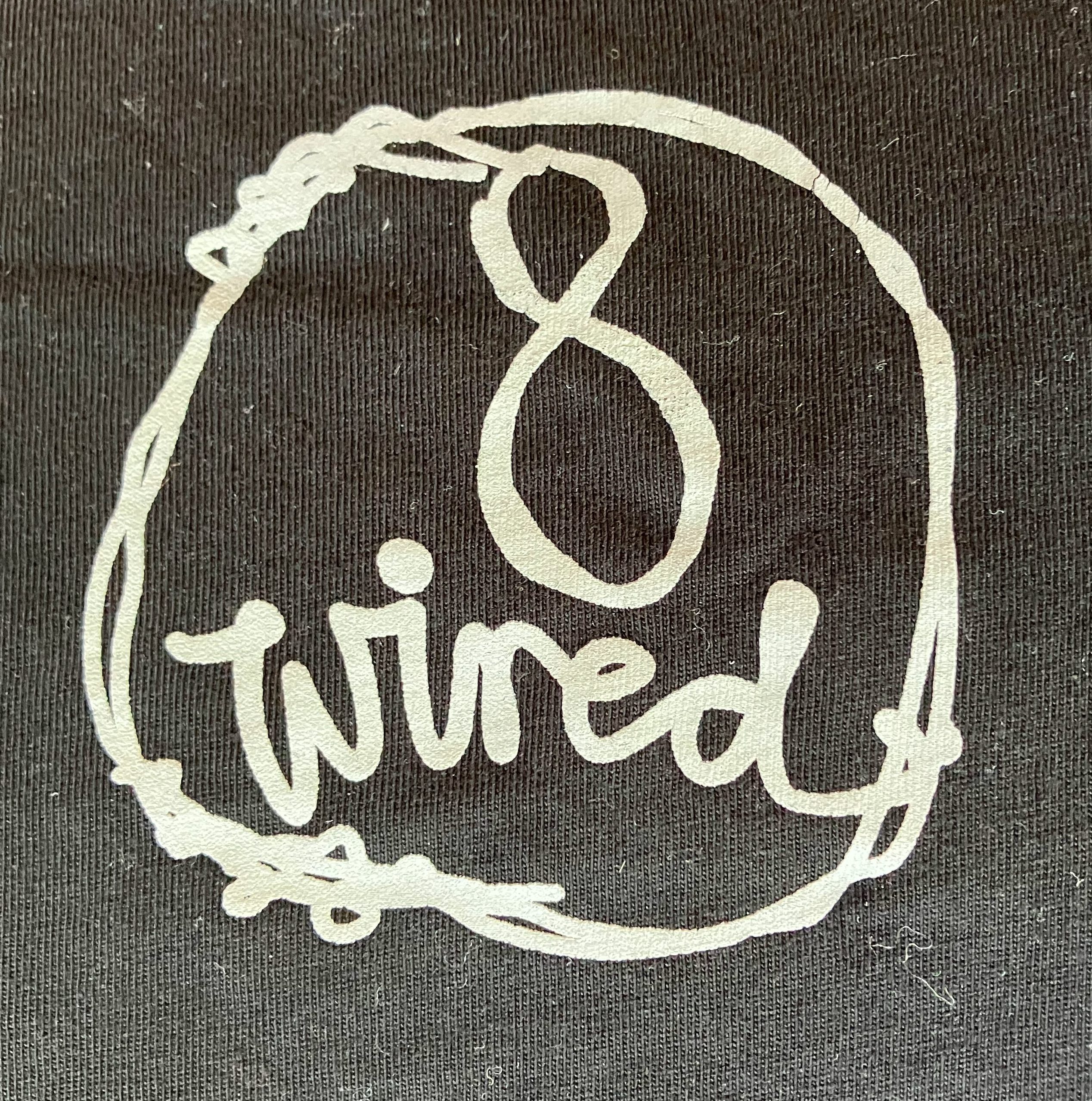photo of a white logo on a black background. it reads "8 wired" in script inside a circle of twisted wires.