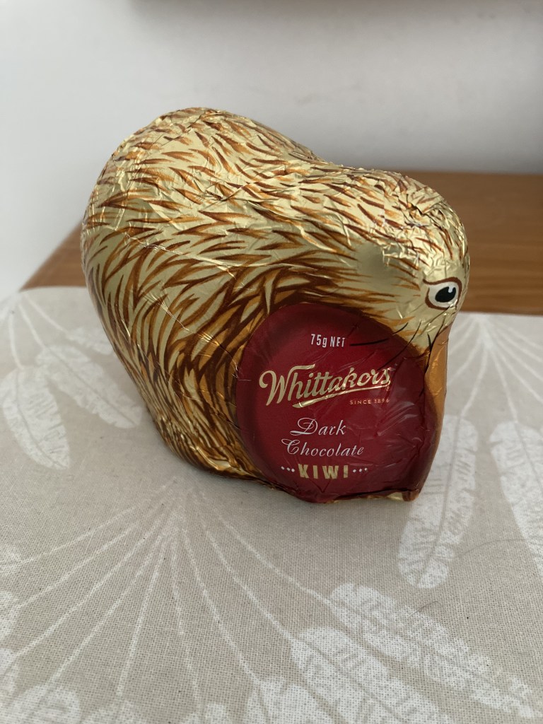 photo of a gold foil-covered chocalate in the shape of a kiwi bird