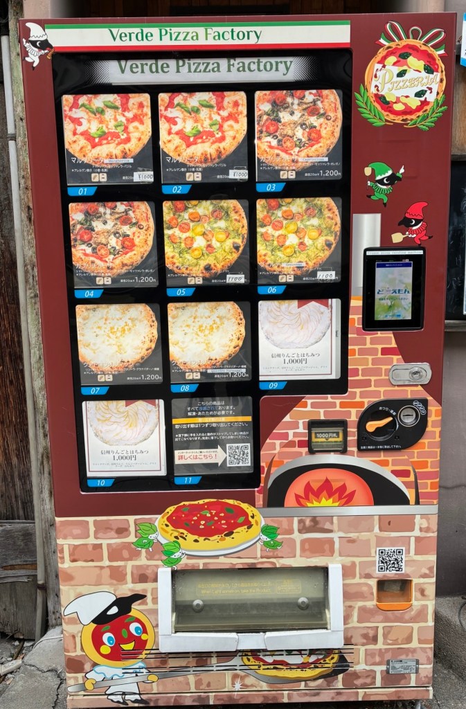 photo of a vending machine labeled "Verde Pizza Factory" with pictures of various pizzas on the front